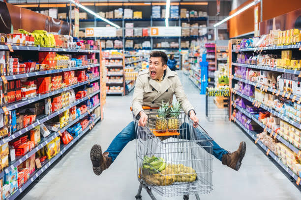 guy in supermarket with trolley 