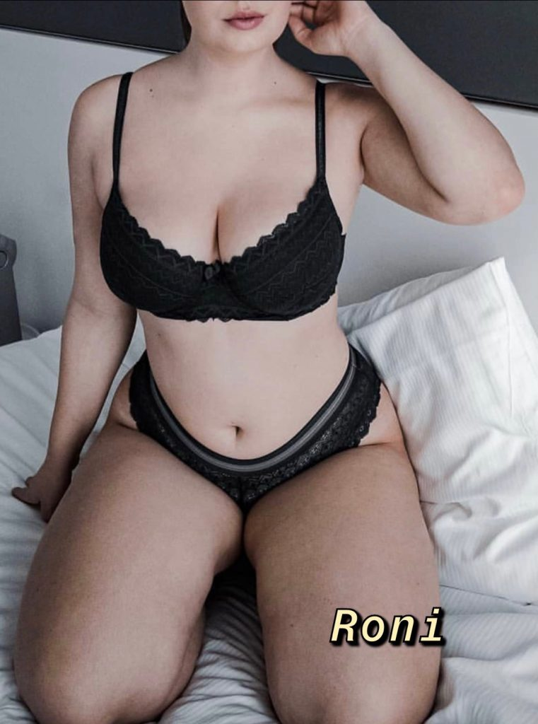 Curvy busty Aussie escort in black lingerie