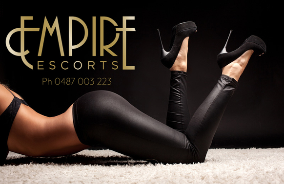 Tanned slim escort in black tights and stilettoe heels