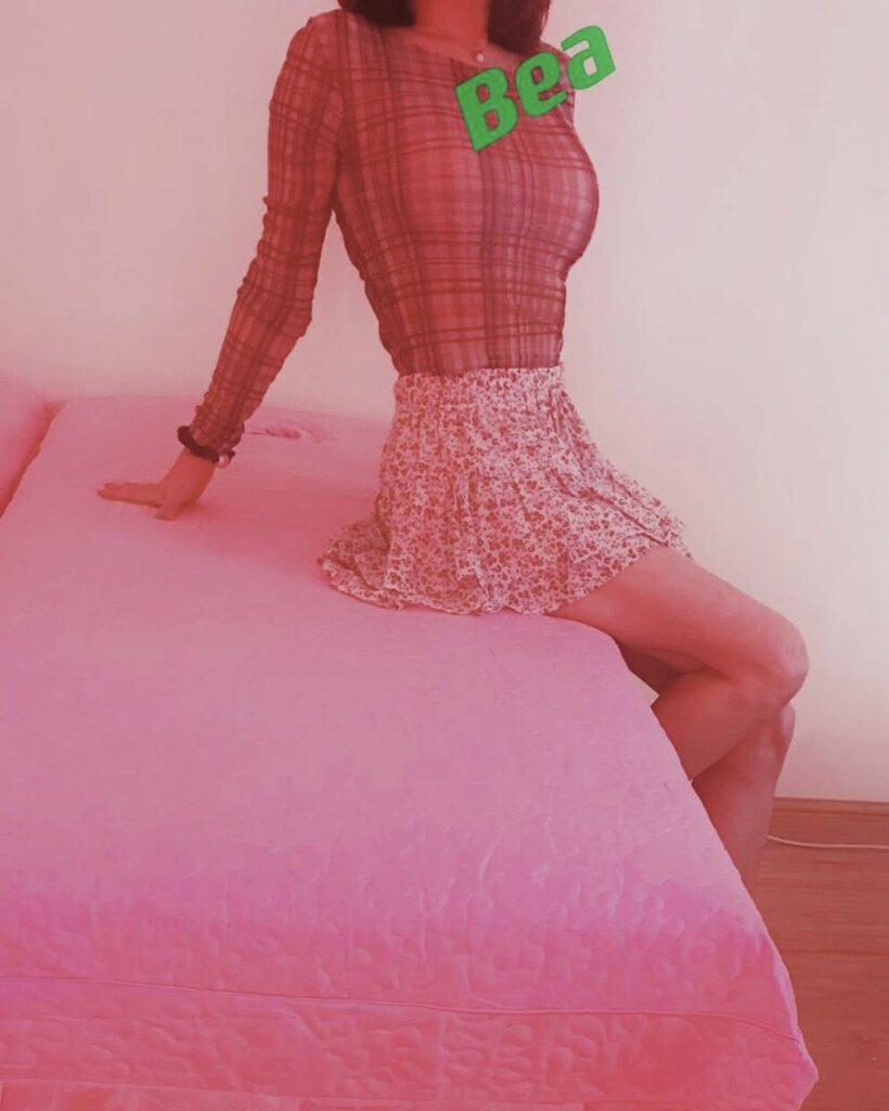 Bea sitting on bed