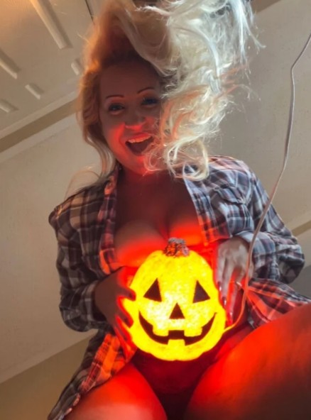 naked Blonde holding Halloween lamp