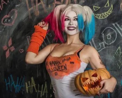 smiling sporty Blonde holding pumpkin
