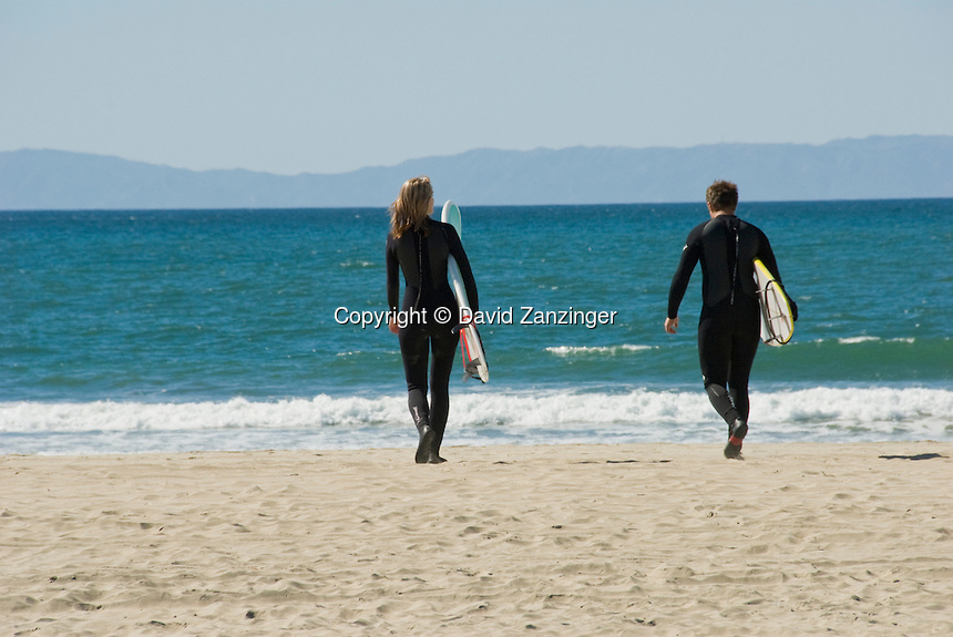 Woman-Man-20s-Surfers-walking-with-Surfboard.jpg