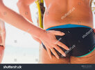 stock-photo-man-s-ass-swimming-trunks-the-woman-left-a-trail-of-sand-on-her-hand-the-beach-136...jpg