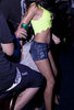girl dancing in blue shorts and green top