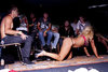 blonde in pink bikini on ground in front of guys