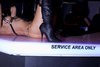 knacked girl in black boots laying on bar