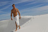 sexy-man-wearing-a-towel-walking-on-a-sand-dune-in-White-Sands-NM.jpg