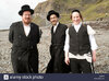 three-male-orthodox-hassidic-jews-on-summer-holiday-on-the-beach-at-C68BTR.jpg